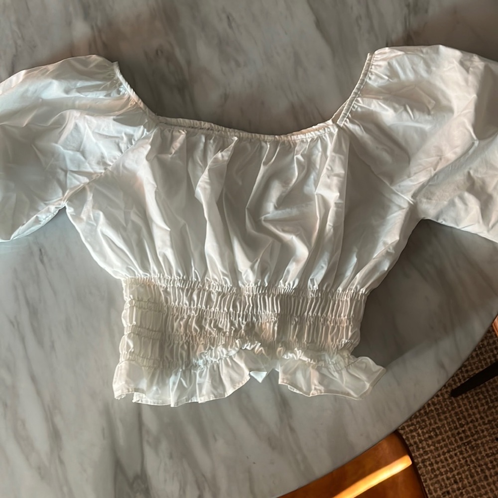 White off sleeve top with smocked waist. One size